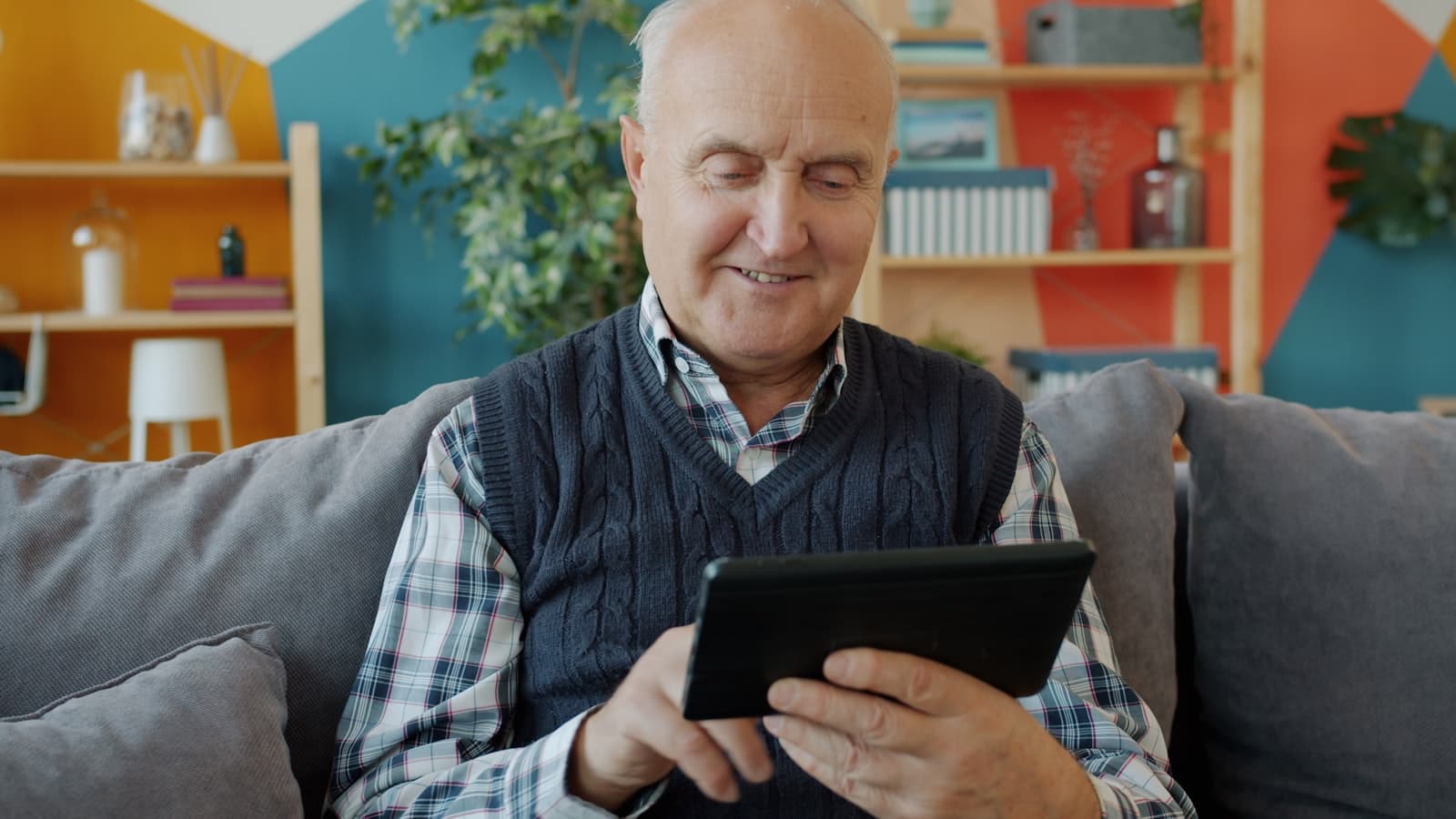 An older adult confidently using a tablet, focused and at ease with the device.
